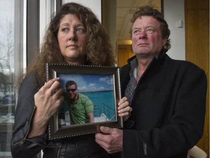 Myles Gray parents with photo of their son